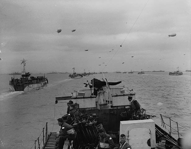 RCN photographer Gib Milne takes this photo from the bridge of LCI 306, looking over the bow at the other LCI headed towards Normandy.